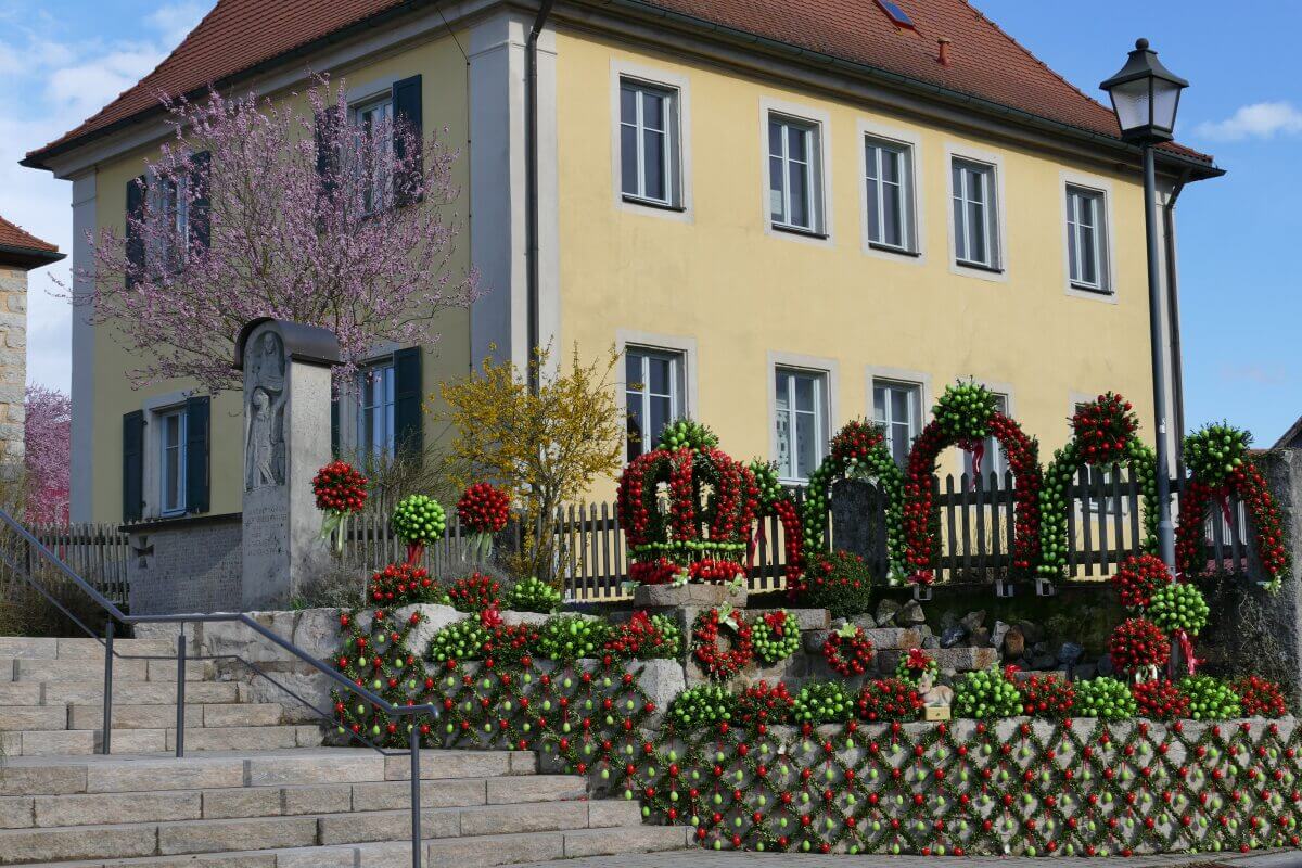 Breunnen mit roten und grünen Ostereiern
